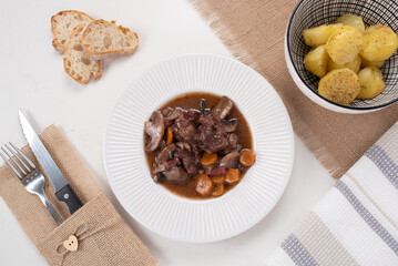 Beef bourguignon, recipe. French cuisine. Beef, mushrooms, red wine, onion, olive oil, carrots, herbs. 