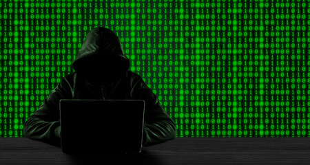 Cybercrime concept. No face hacker with laptop with binary code background.