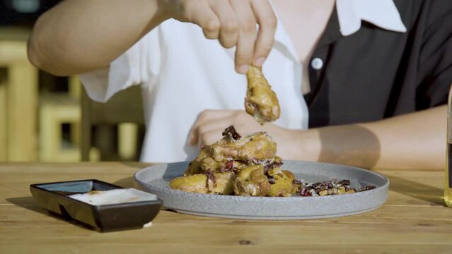 Eating chicken wings with chipotle dip