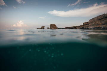 Half underwater shot of sea rocks near coastline