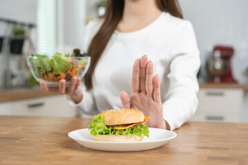 Diet, Dieting asian young woman, girl close up hand push out, deny hamburger, junk food and choose green salad, vegetables salad, eat food for good health when hungry. Female weight loss people.