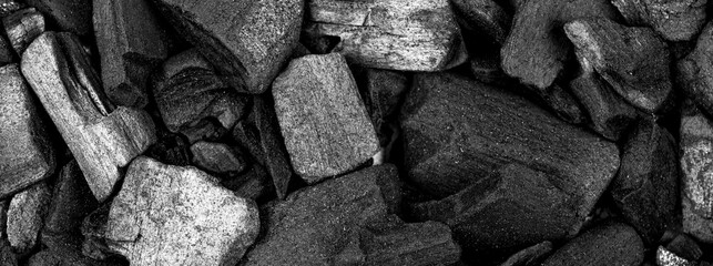 Randomly scattered pieces of black charcoal