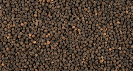 Close-up of black peppercorns, facing straight ahead.