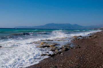 Fototapeta na wymiar East shore of Rhodes Island with big waves and rocky beach