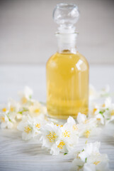 Obraz na płótnie Canvas medicinal herbal tincture with jasmine in a glass bottle