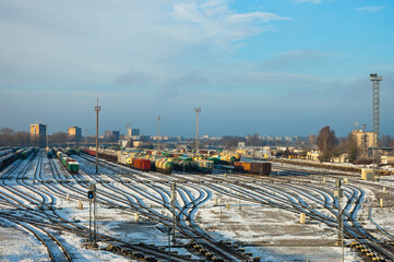 railway tracks, diesel locomotive and railway wagons against the blue sky