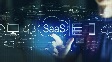 SaaS - software as a service concept with young man touching a digital screen at night