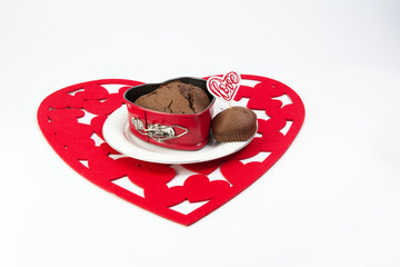 Chocolate heart-shaped muffins with heart and love on red hearts - obrazy, fototapety, plakaty