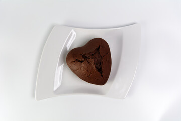 Chocolate heart-shaped muffin on flat lay picture