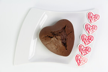 Chocolate heart-shaped muffin with heart and love on flat lay picture