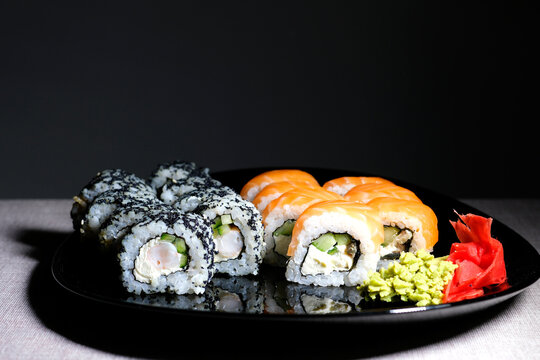set Philadelphia and California oriental cuisine japanese food vegetarians adore on a beautiful dark background sushi bar outrageous rolls appetizing fish and rice wrapped in nura on atmospheric