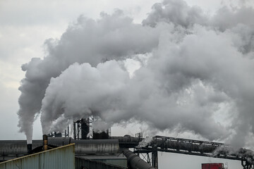Fototapeta na wymiar smoke stacks from factory in winter sky