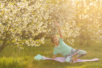 little girl is doing fitness in the yard