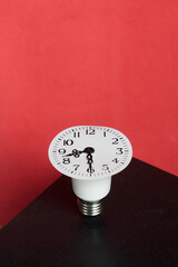 Light bulb with clock face. arrows at 20:30. Global ecology, International Energy Saving Day or Earth Hour concept.