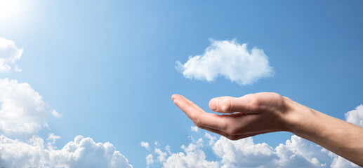 Male hand holding house icon on blue background. Property insurance and security concept.Real estate concept.Weather conditions, cloudiness.Banner with copy space