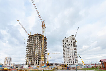Fototapeta premium Crane and building under construction against blue sky