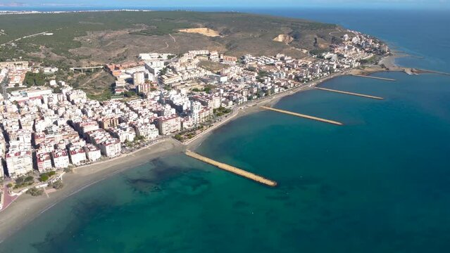 Cinematic aerial perspective of Santa Pola city. Travel destination in southeast of Spain, Valencian Community. Drone truck right. Wide panoramic view of all region. View of Llevant Beach area