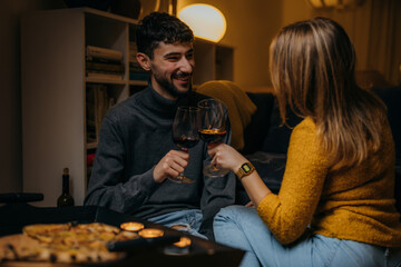 Boyfriend and girlfriend have a toast with a glass of red wine