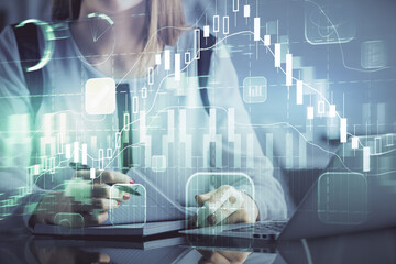 Fototapeta na wymiar Double exposure of businesswoman hands typing on computer and financial graph hologram drawing. Stock market analysis concept.