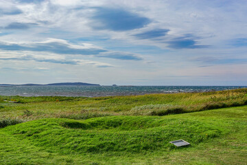Newfoundland, Canada: A foundation marker at L’Anse-aux-Meadows (trans. Meadows Cove), the archeological site of a Norse settlement dating from 990 to 1050 CE.