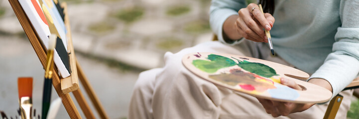 Female artist painting art canvas drawing with inspiration in garden art therapy creativity...