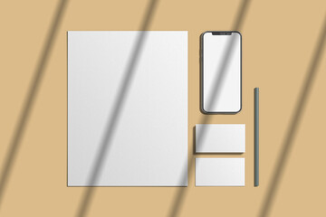 Notebook, pencils, stationery and templates of different shapes on a yellow background.