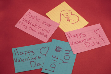 Five Colorful and Diffrent Signs with Valentine's Day Words Written on them (Love, Happy valentine's Day) Isolated on Red Background and Roses on the sides