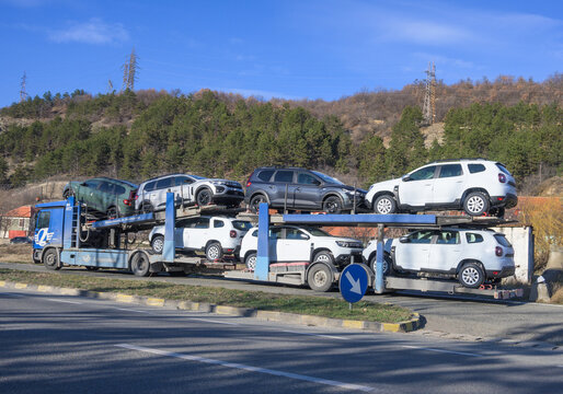 Car transporter truck - New cars, Dacia Duster. Car transporter carries. Romania, Mehedinti. February, 07, 2023