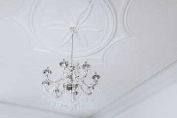 decorative ceiling with an antique chandelier
