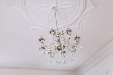 decorative ceiling with an antique chandelier