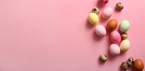 Painted Easter eggs on pink background with space for text