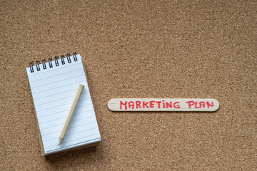 Background With A Notepad And A Pencil And A Piece Of Wood That Has Written By Hand, Marketing Plan