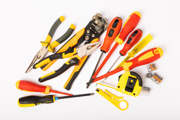 Electrician tools isolated on white background.Electrician tools set. Construction tape measure, screwdrivers, pliers, wire stripper, clamp and automatic insulation stripper.
