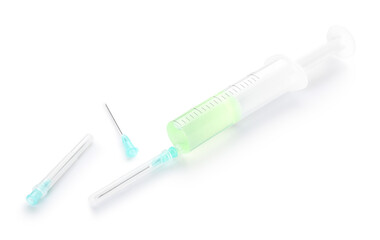 Medical syringe with remedy and needles on white background