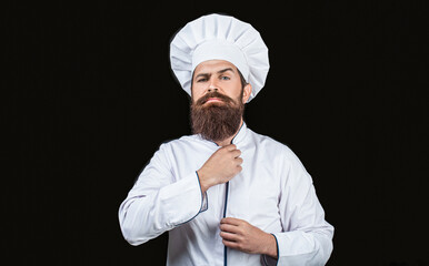Bearded chef, cooks or baker. Bearded male chefs isolated on black. Cook hat. Confident bearded male chef in white uniform. Serious cook in white uniform, chef hat. Portrait of a serious chef cook