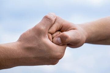 Helping hand outstretched, arm, salvation. Friendly handshake, friends greeting, teamwork, friendship. Rescue, helping gesture or hands. Two hands, helping arm of a friend
