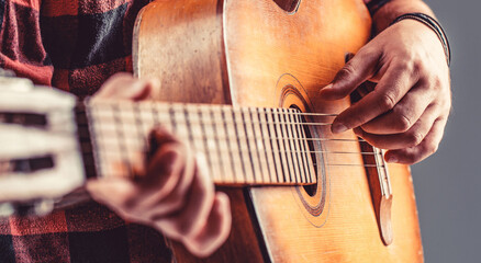 Guitarist on stage. Close up hand playing guitar. Guitars acoustic. Male musician playing guitar,...