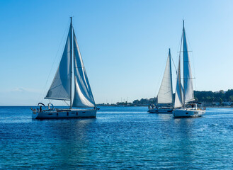 Fototapeta premium boats and yachts at the sailing regatta on open water. Sailing on the wind waves in the sea.