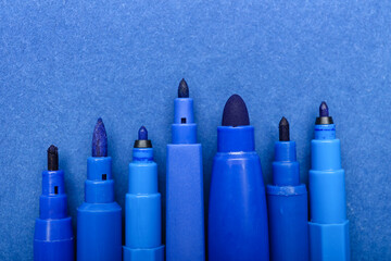 Felt-tip pens on blue background