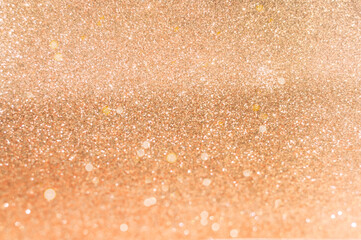 Festive background in shades of golden with golden sparkles. Atmospheric mood of the Year 2024. Festive background concept for Valentine's Day or Mothers Day. Blurred effect