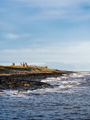 Fototapeta na wymiar Dunstanburgh Castle on the Northumberland coast with copy space