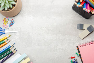 Back to school concept. School supplies on black board background.