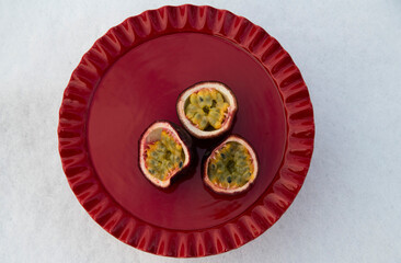 Passion fruit on red plate 