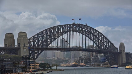 Sydney Harbour Bridge arch and pylons seen from Circular Quay railway station-misty overcast sky. NSW-Australia-480