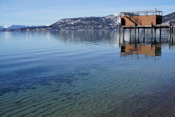 Fototapeta na wymiar clear water and wooden house boat pier in in Lake Tahoe, CA, USA