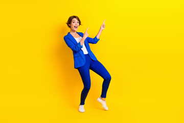 Fototapeta na wymiar Full length photo of cheerful impressed lady dressed blue blazer showing two fingers empty space isolated yellow color background
