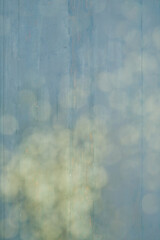 Blue, woodgrain background, with gold bokeh slanting top right to bottom left.
