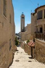 Narrow Street with Old Stone Walls, Buildings, and a Cathedral