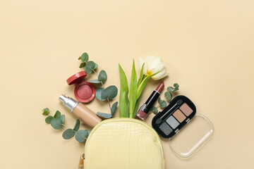 Composition with bag, cosmetics, tulip flower and eucalyptus branches on color background