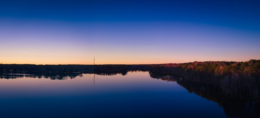 beautiful aerial drone view of a lake sunrise at the blue hour of twilight.